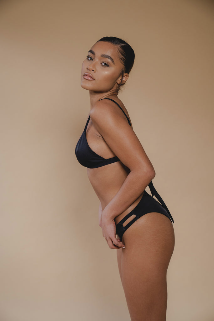 jua june sustainable swimwear. a black triangle bikini top combined with a black high leg bikini bottom. made of ecofriendly materials, high quality swimwear. luxury swimwear.