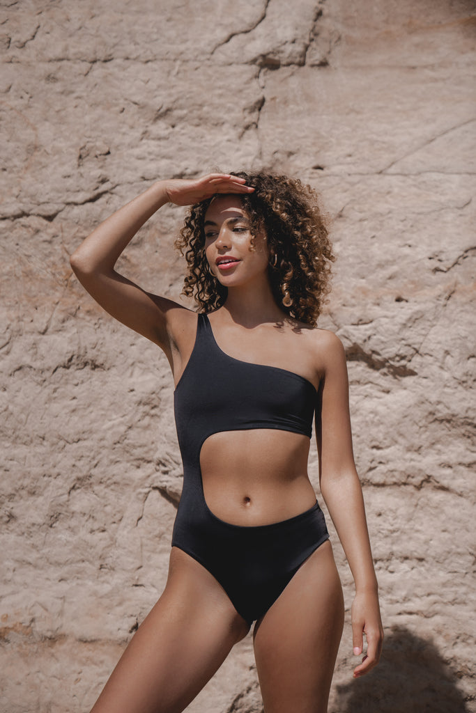 swimsuit. black swimsuit. one shoulder swimsuit. cut out swimsuit. cheeky swimsuit. bandeau swimsuit. sustainable swimwear. eco friendly.